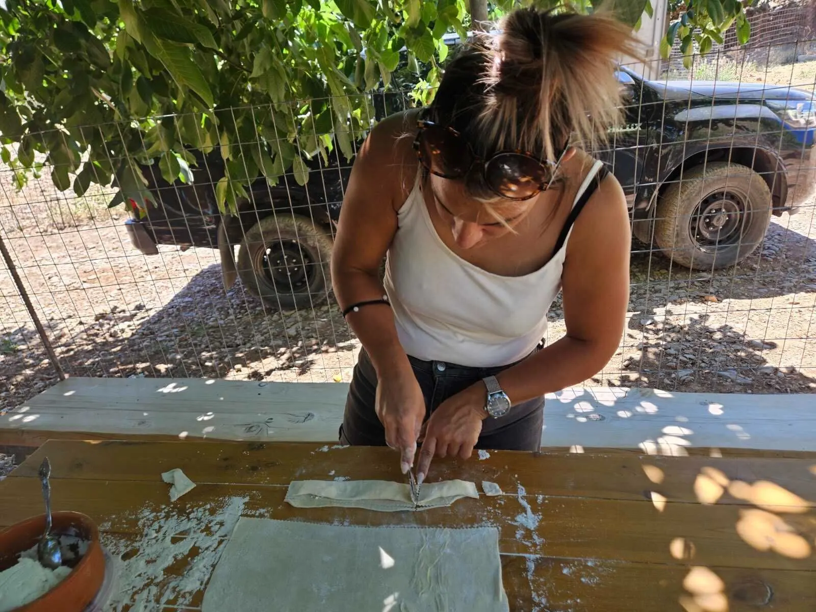 Iro is making Cretan Kalitsounia with cheese and herbs from the Arevitis Farm!