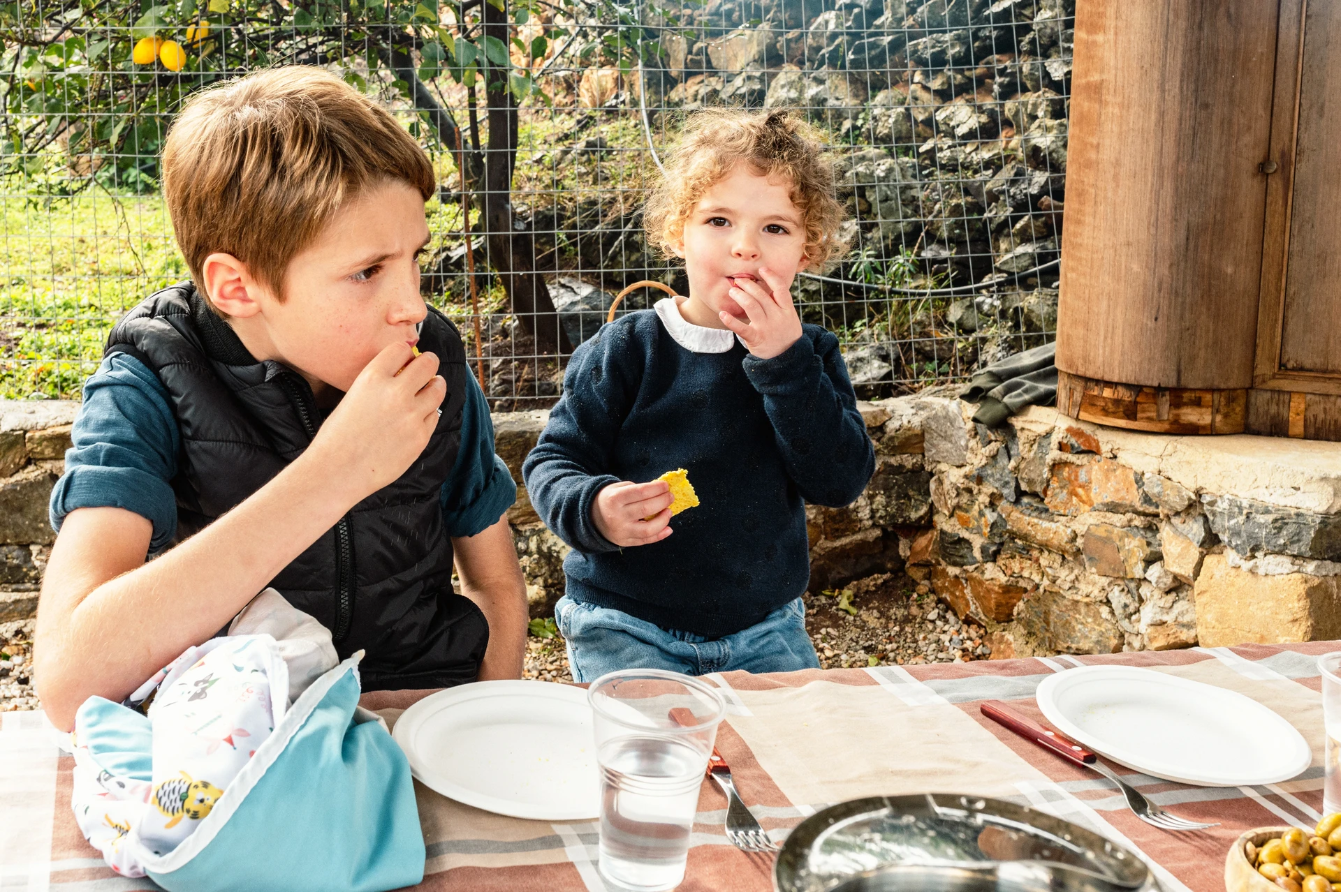 Gilr and boy eating at Arevitis farm Chania Crete